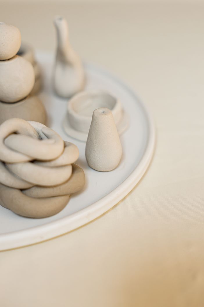 Handcrafted stoneware cups arranged on a warm beige backdrop, photo by Cup of Couple on Pexels