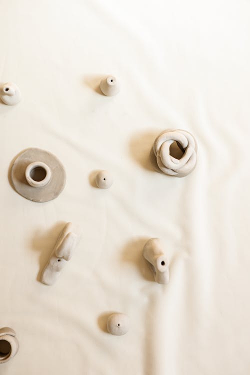 Top View of White Plasticine Shapes on White Background