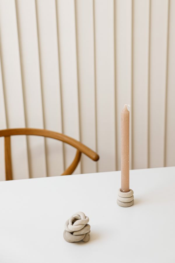 Beige candle in a clay holder — photo by Cup of Couple on Pexels