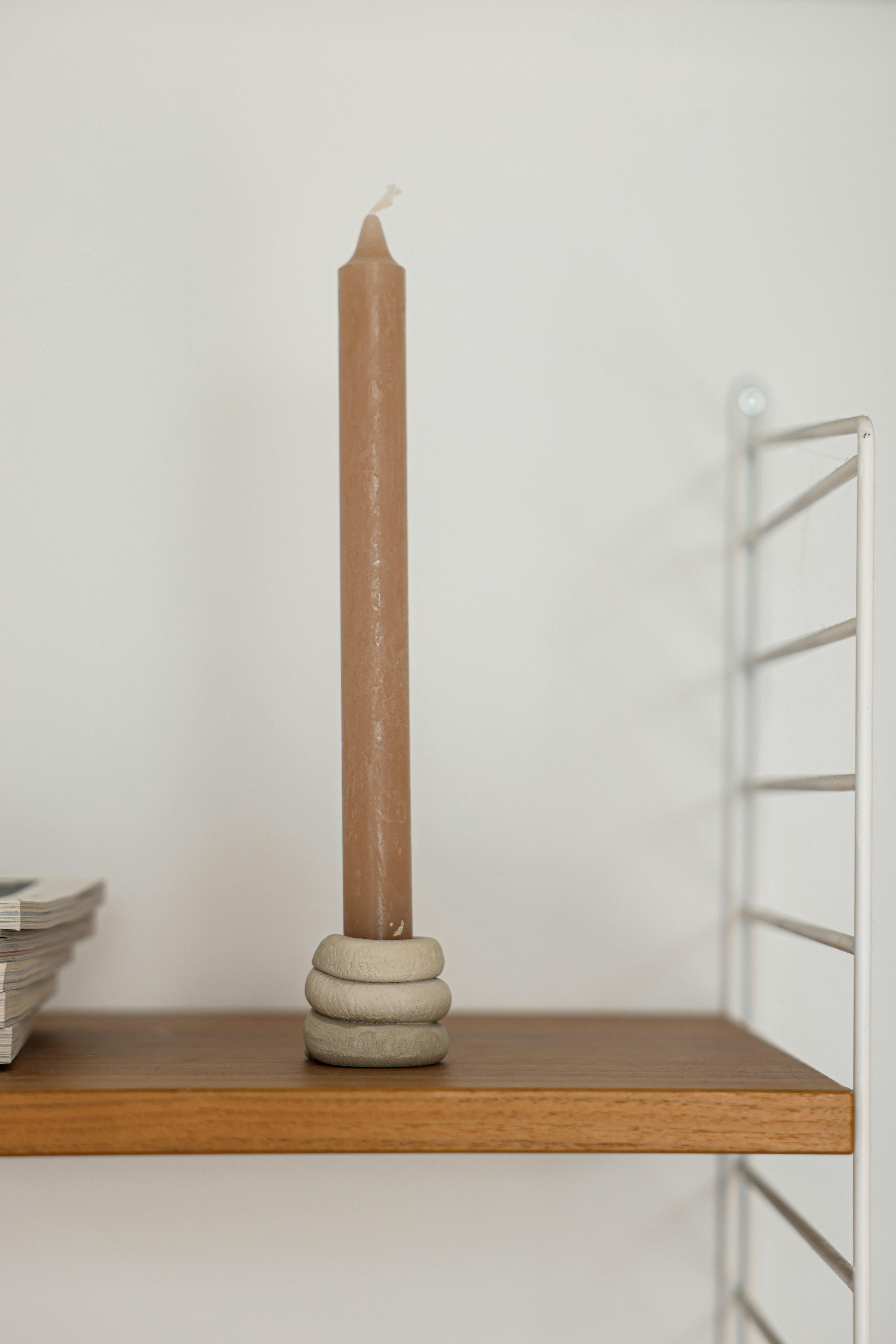 a candle on a wooden table