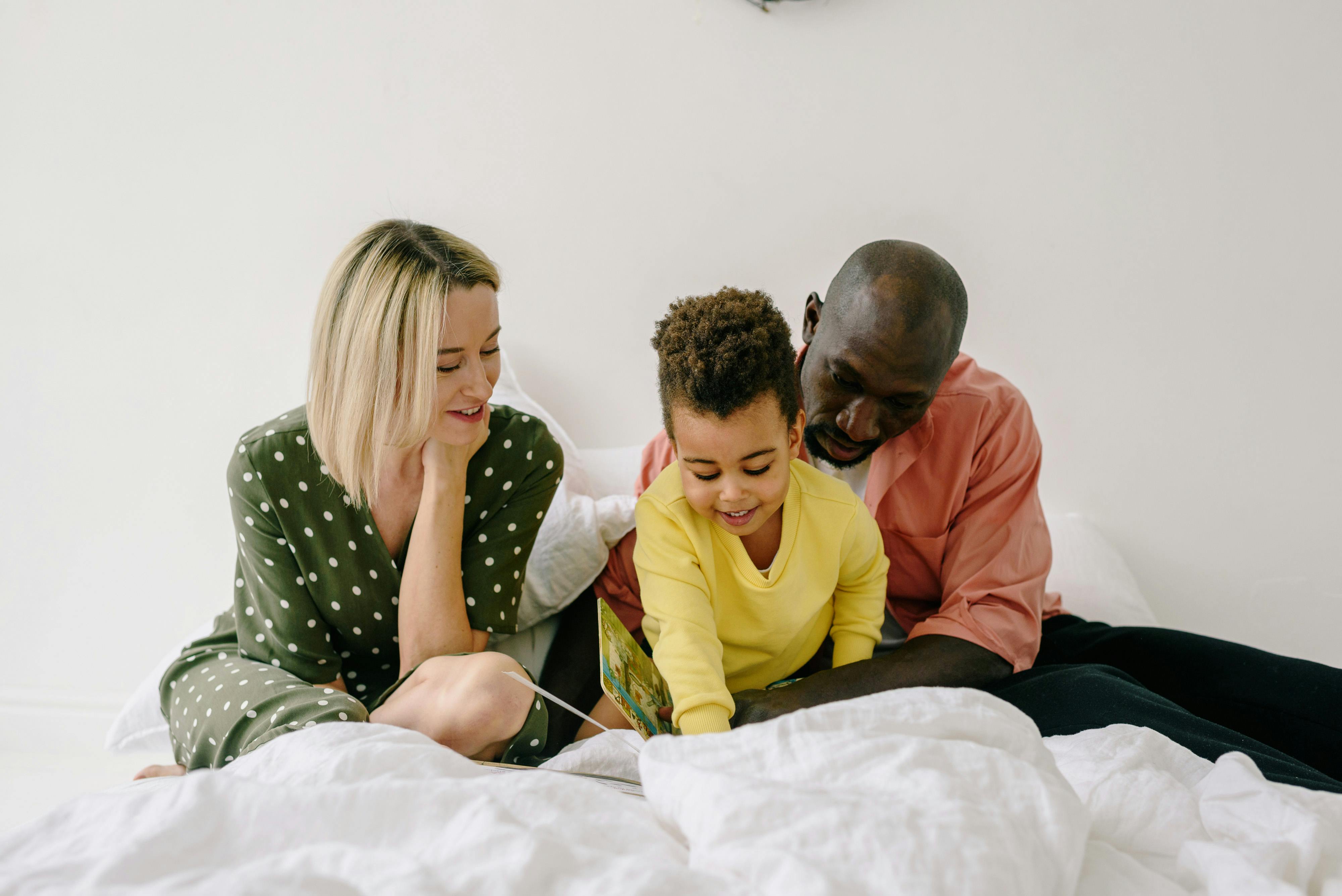 photograph of a family on a bed