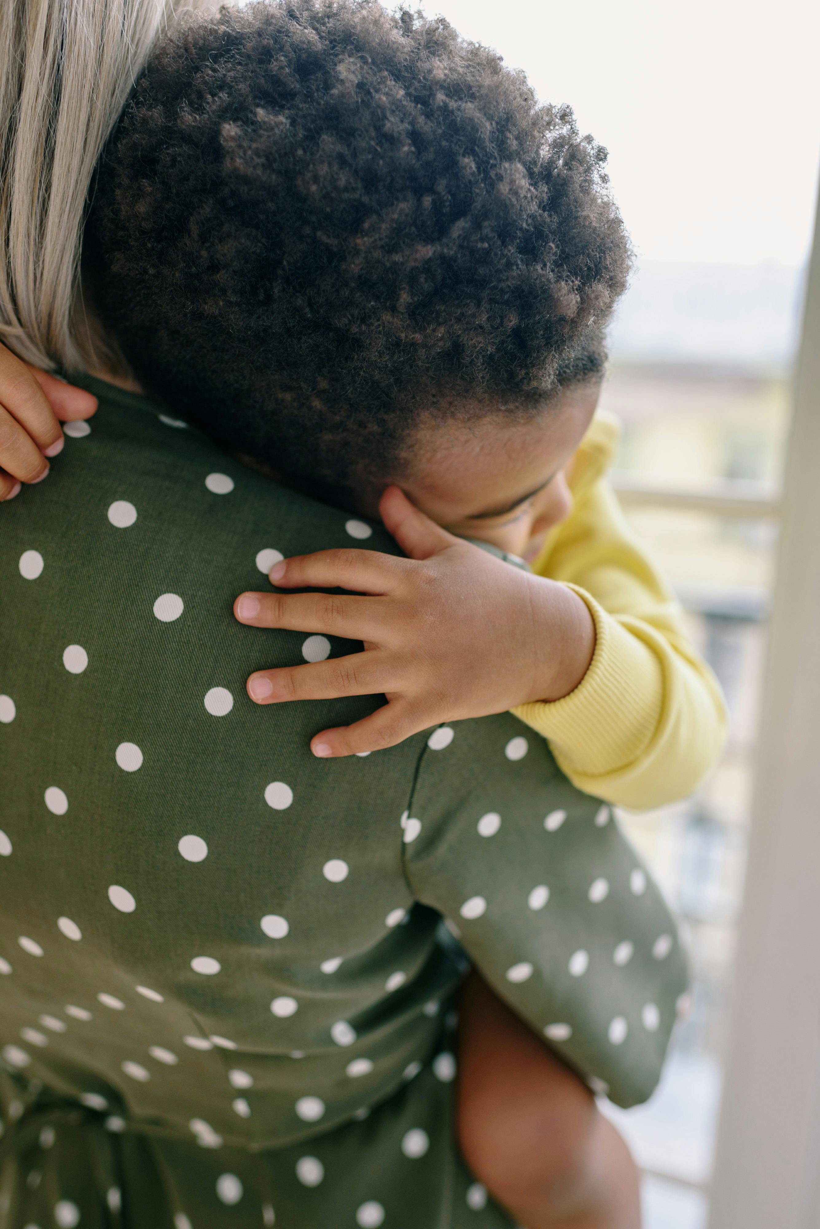 a child hugging his mother