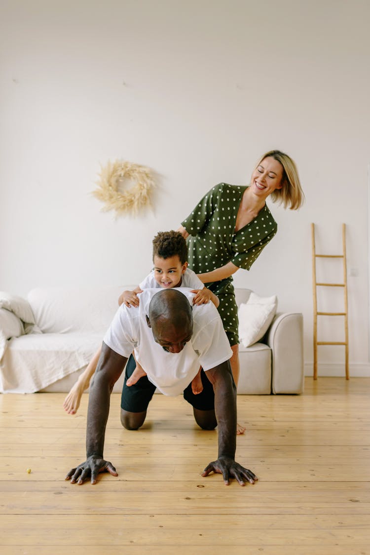 A Man Doing Push Ups With His Family