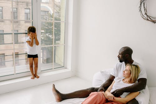 Free A Boy Covering His Face from His Parents Stock Photo