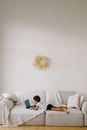 Little Boy Laying on Sofa while Using a Laptop