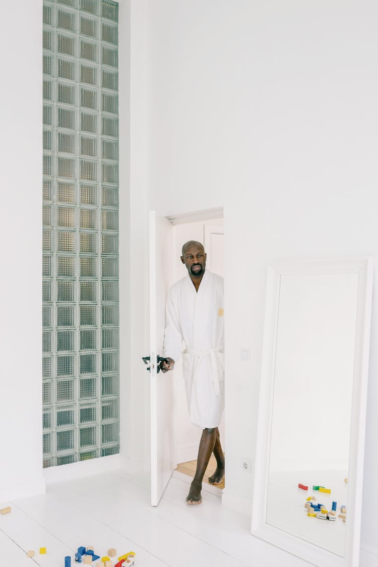 Man Wearing A Bathrobe Entering A Room