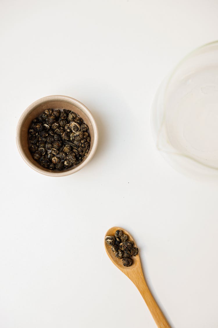 Bowl Of Black Beans Near Wooden Spoon With Black Beans