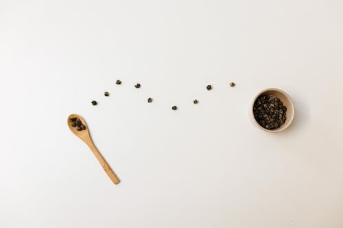 Free Tableware and White Surface with Black Beans Stock Photo