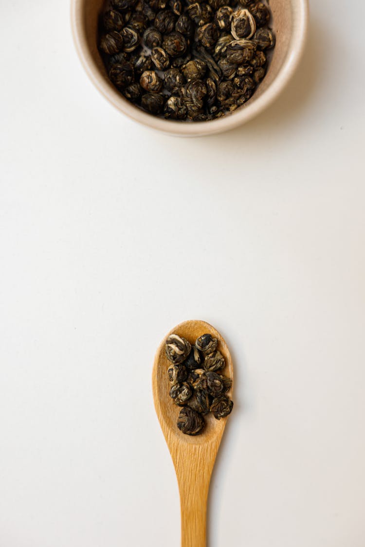 Black Peppercorns On Tableware