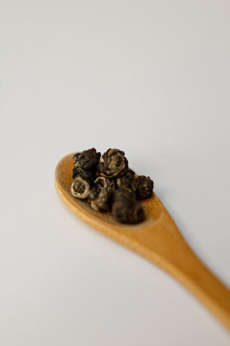 Black Peppercorn On Brown Wooden Spoon