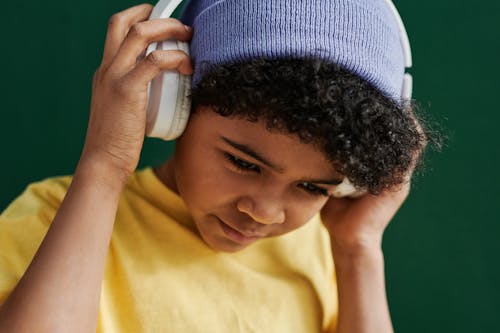 A Young Boy Listening Music on the Headphones