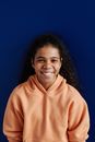 Smiling Young Woman in Orange Hoodie Sweater