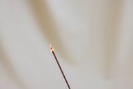 Lighted Cigarette Stick on White Surface