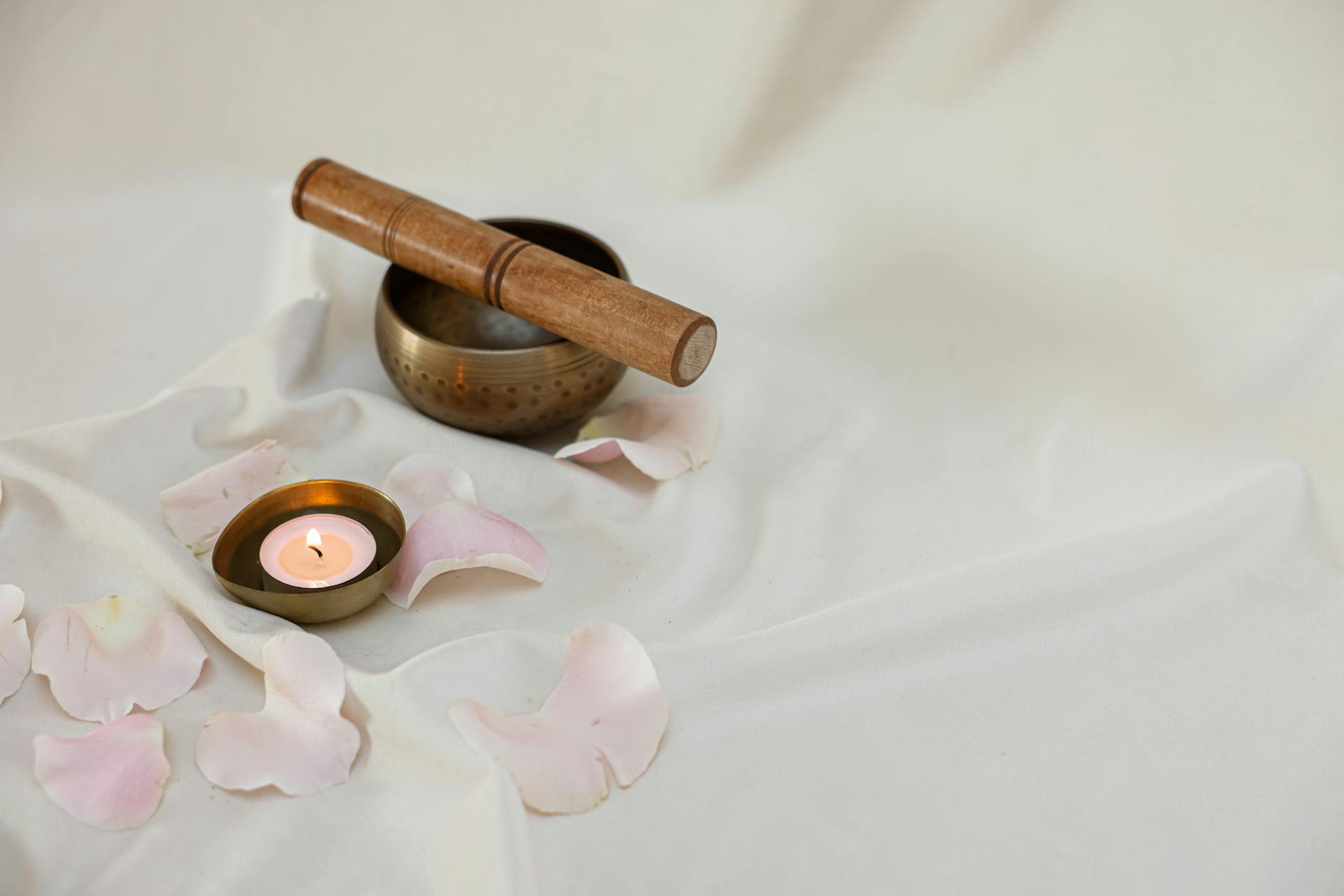 Lighted Candle Beside a Tibetan Singing Bowl