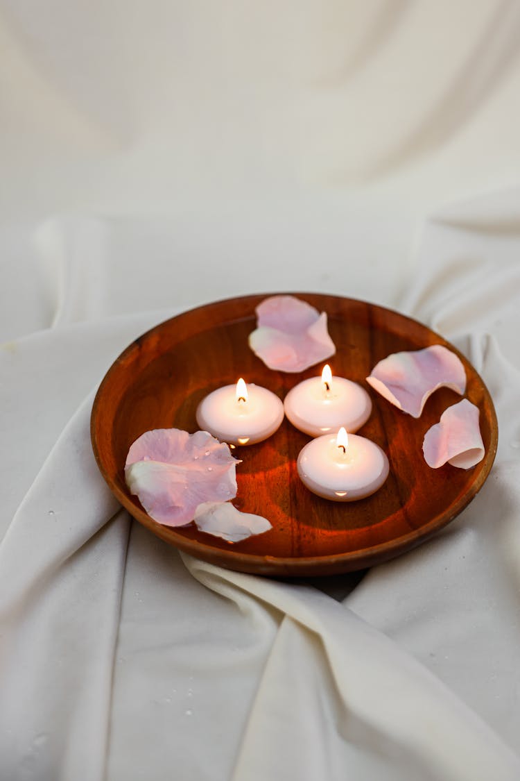 Flowers Petals On Plate With Burning Wax Candles