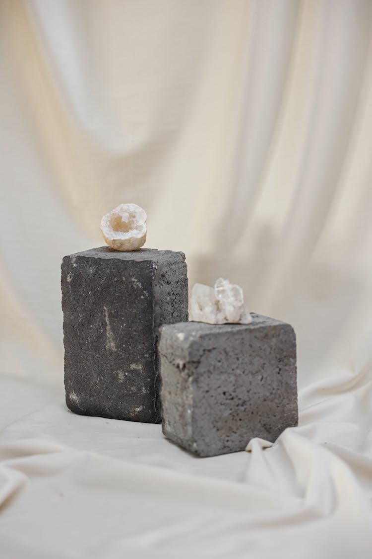 Still Life With White Minerals On Gray Concrete Cubes And Fluid Fabric