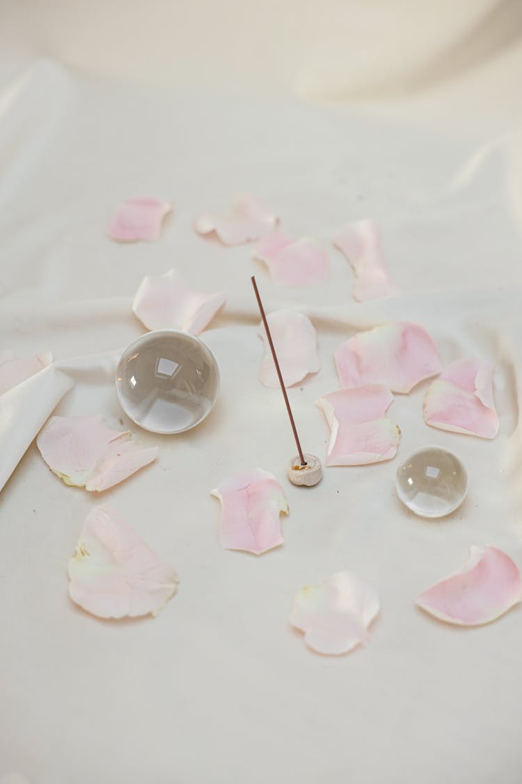 Clear Glass Balls Surrounded With Pink Flower Petals 