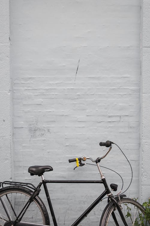 A Bicycle Leaning on White Wall