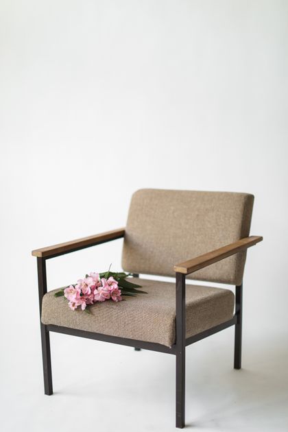 Upholstered armchair on a white backdrop, photo by Cup of Couple on Pexels