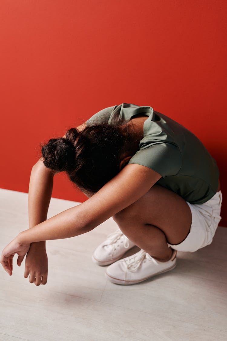 Photo Of An Upset Kid Crouching