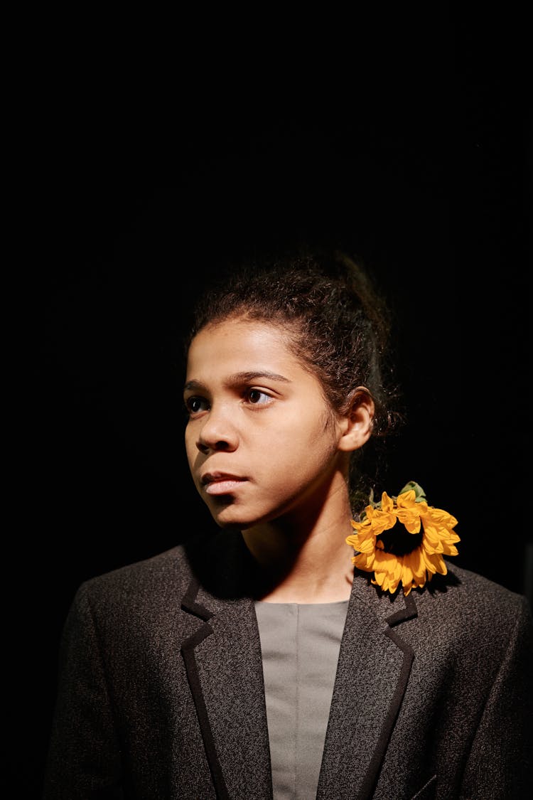 A Woman Wearing A Blazer With Sunflower On Her Shoulder