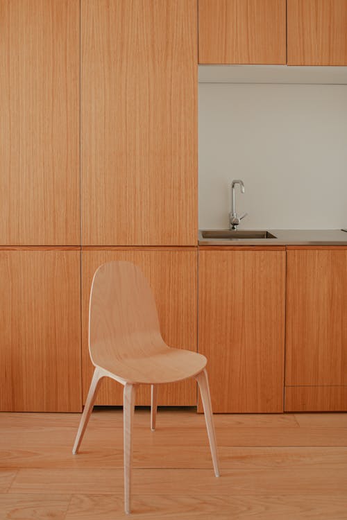 A Home Interior with Wooden Chair and Cabinets on the Kitchen