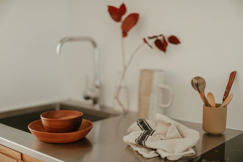 Free A modern kitchen sink with wooden utensils and a minimalist decor vibe. Stock Photo