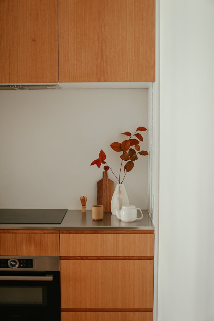 Autumnal Decoration From Red Leaves On The Side Of A Counter In A Modern Kitchen 