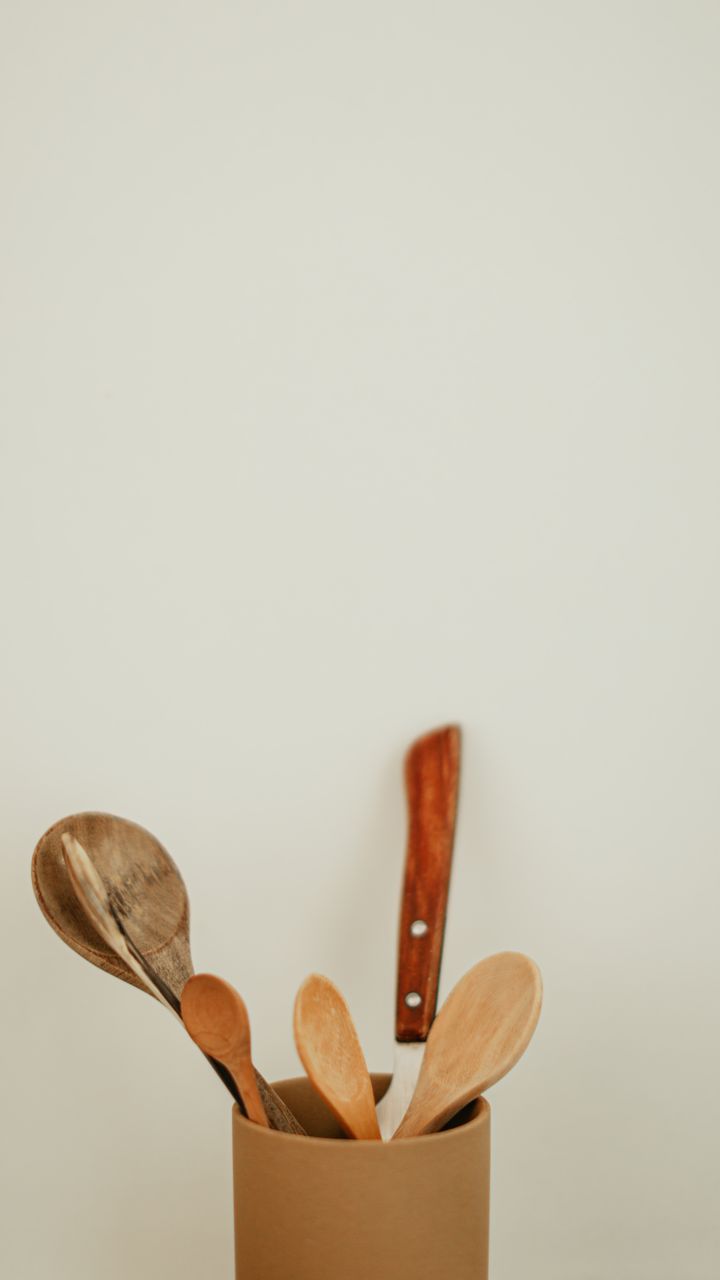 Colorful painted wooden spoons tied together as a utensil holder for a dollar tree coffee bar design