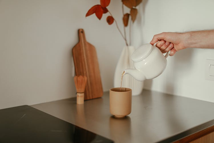 Person Pouring Tea