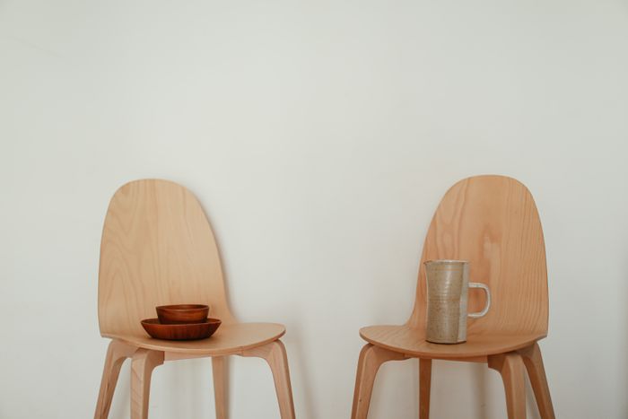 Two bentwood chairs with ceramics — photo by Cup of Couple on Pexels