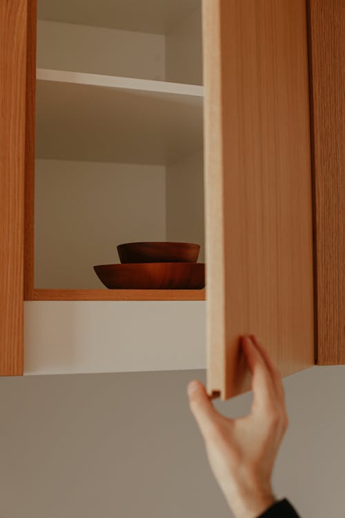 Person Opening a Cabinet