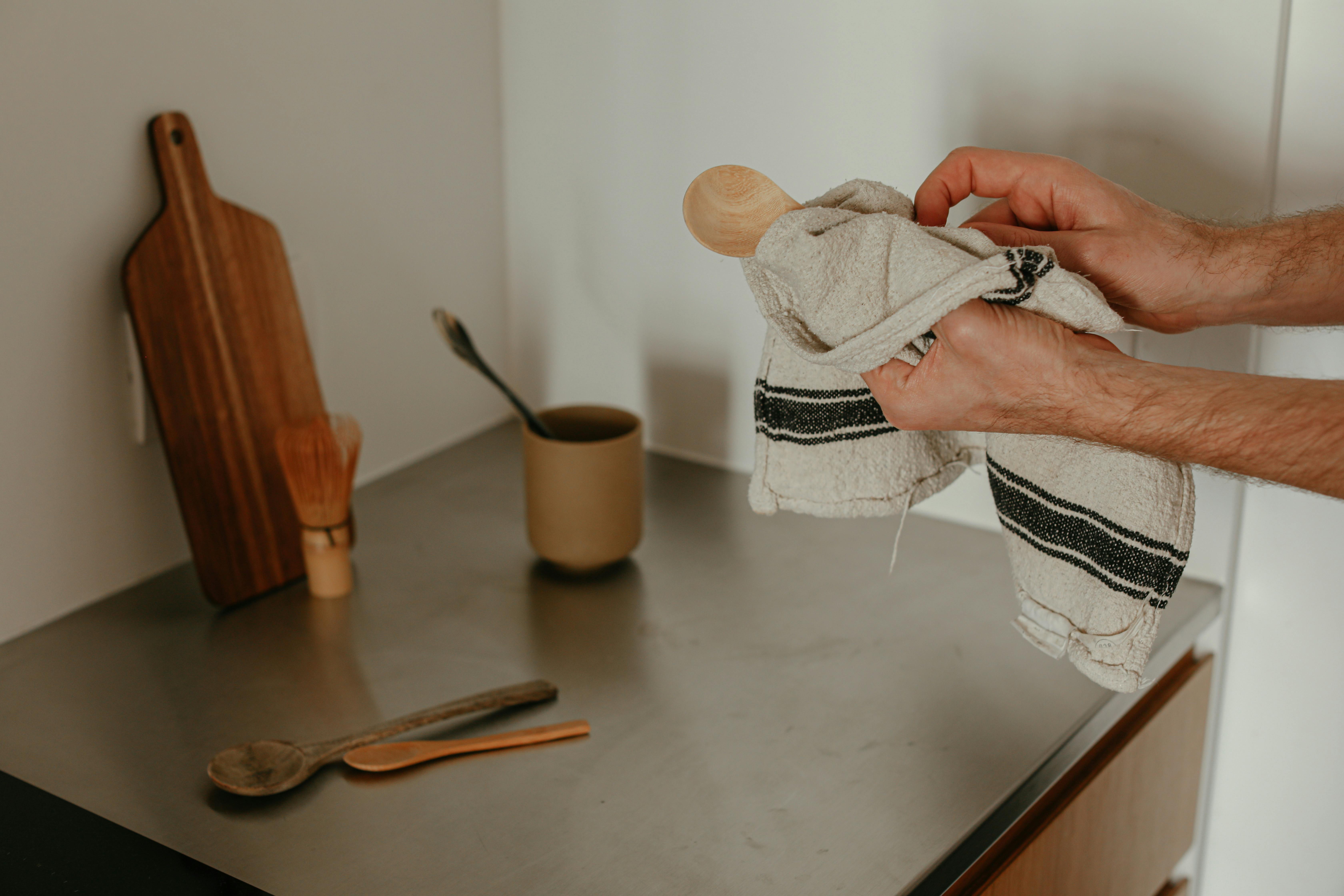 Free A warm and inviting kitchen counter with wooden utensils and a cozy ambiance. Stock Photo