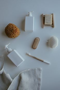 Stylish flat lay of eco-friendly bath essentials, including pump bottles and natural soaps.