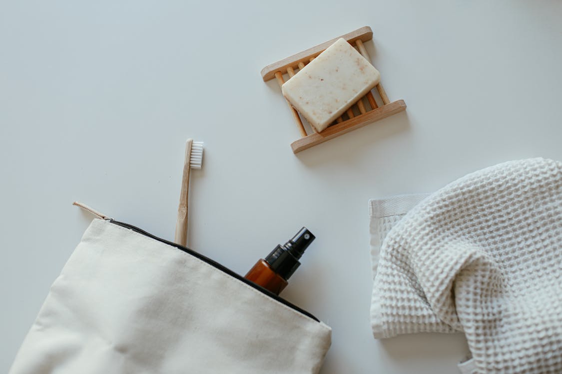 Free Soap, a Towel, a Toothbrush and a Spray Bottle in a Bag Stock Photo