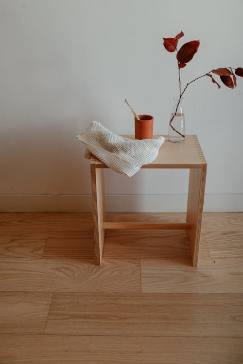 A White Towel Beside a Cup on a Wooden Table