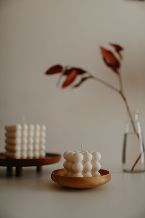 Free Minimalist still life with bubble candles and a simple vase on a neutral background. Stock Photo