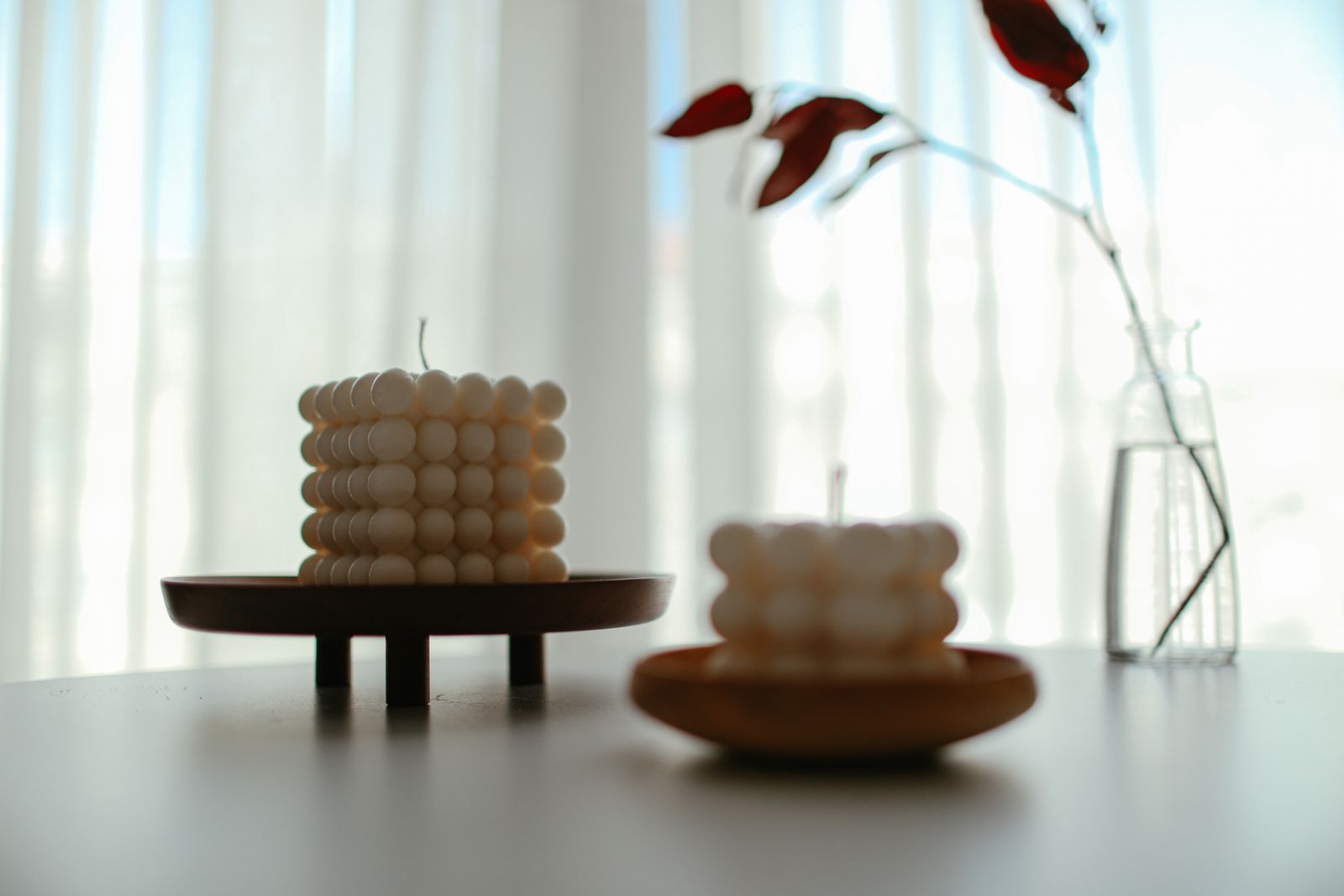 Cube candle and a single stem in a vase