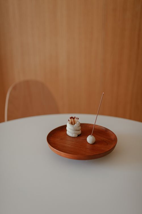 Free Elegant setup featuring a wooden tray with incense and matches, capturing minimalist aesthetics. Stock Photo