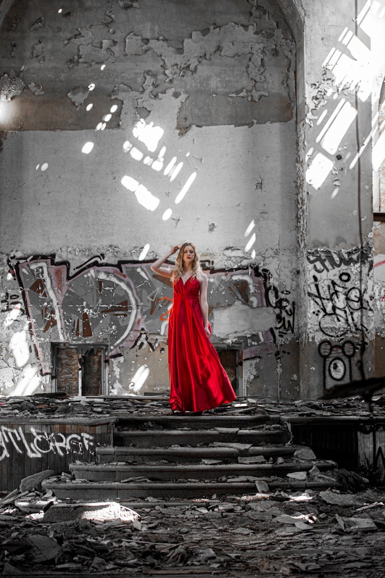 Woman In A Long Red Dress On Desaturated Weathered Background