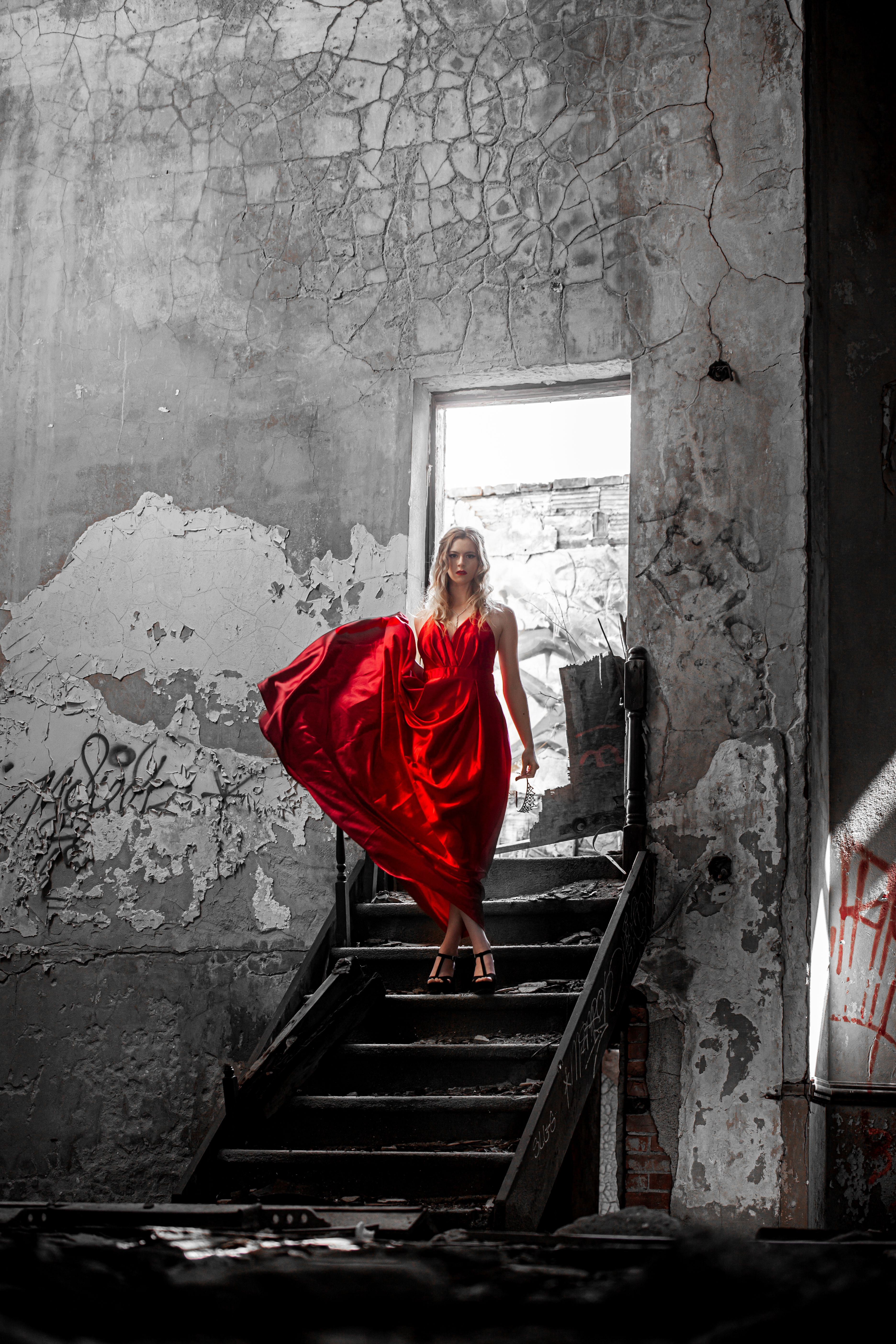 A Woman Standing on the Stairs of an Abandoned Building · Free Stock Photo