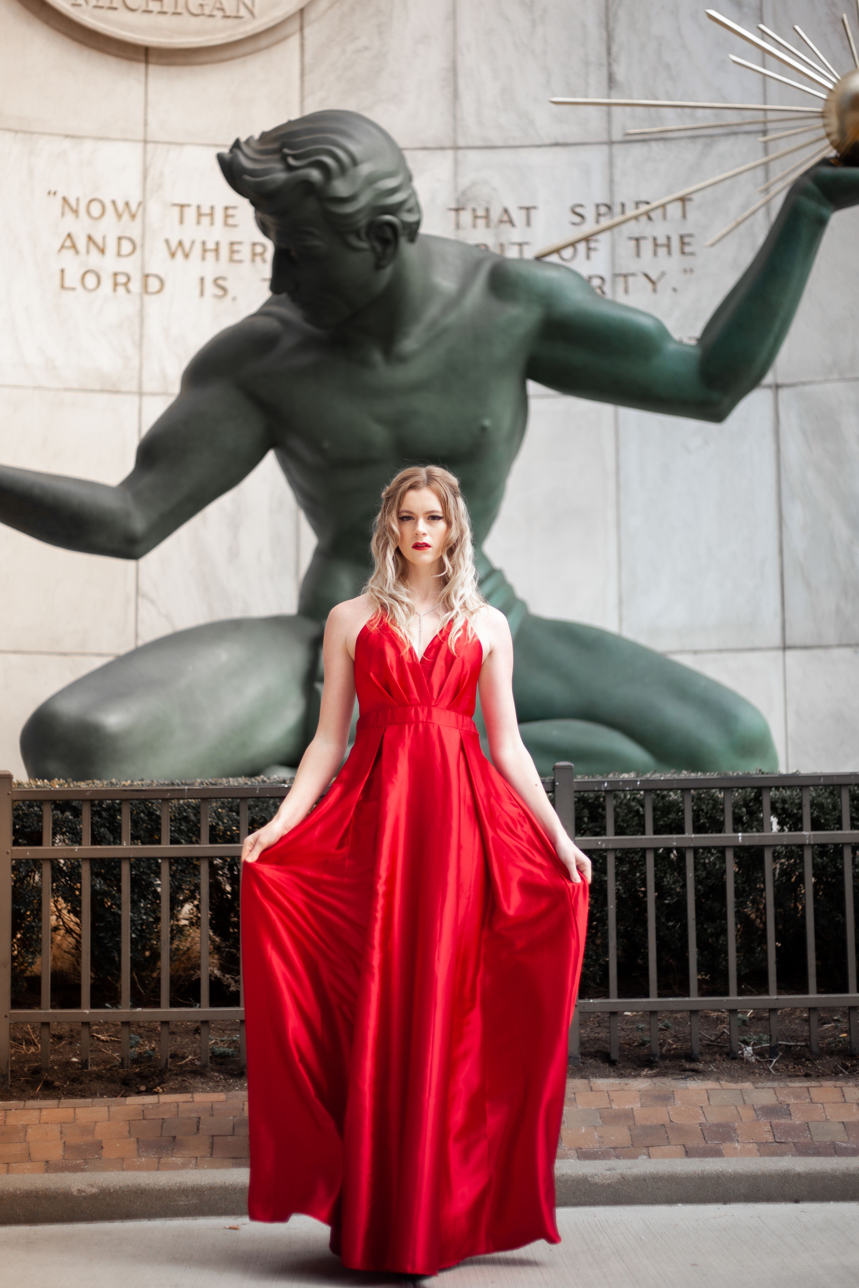A Woman in Red Dress Standing in Front of a Statue · Free Stock Photo