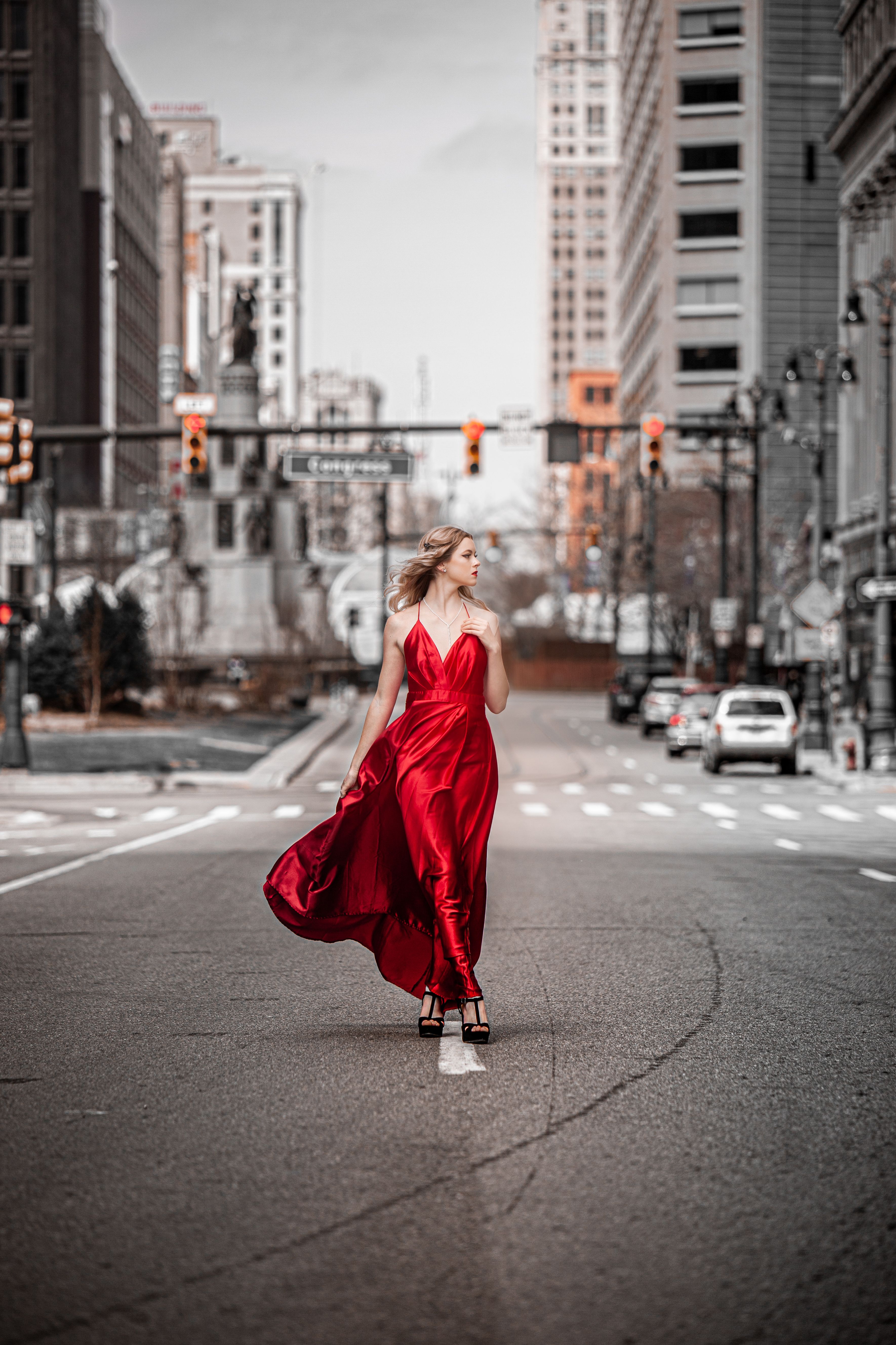 Woman in Red Dress Standing Near a Statue · Free Stock Photo