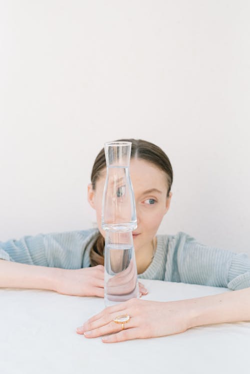 Stacked Glass Items in front of a Woman