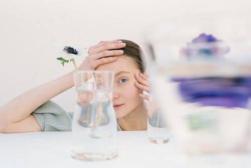 Woman behind a Glass Container