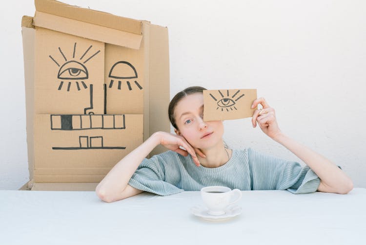 Woman Holding A Cardboard Box With A Drawing