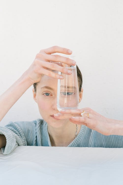 Woman Holding a Clear Glass of Water