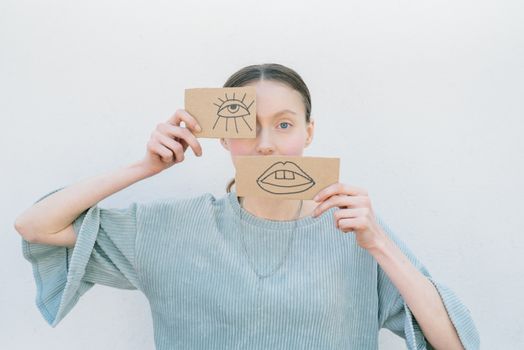 A Woman Holding Cardboard Pieces with Drawings