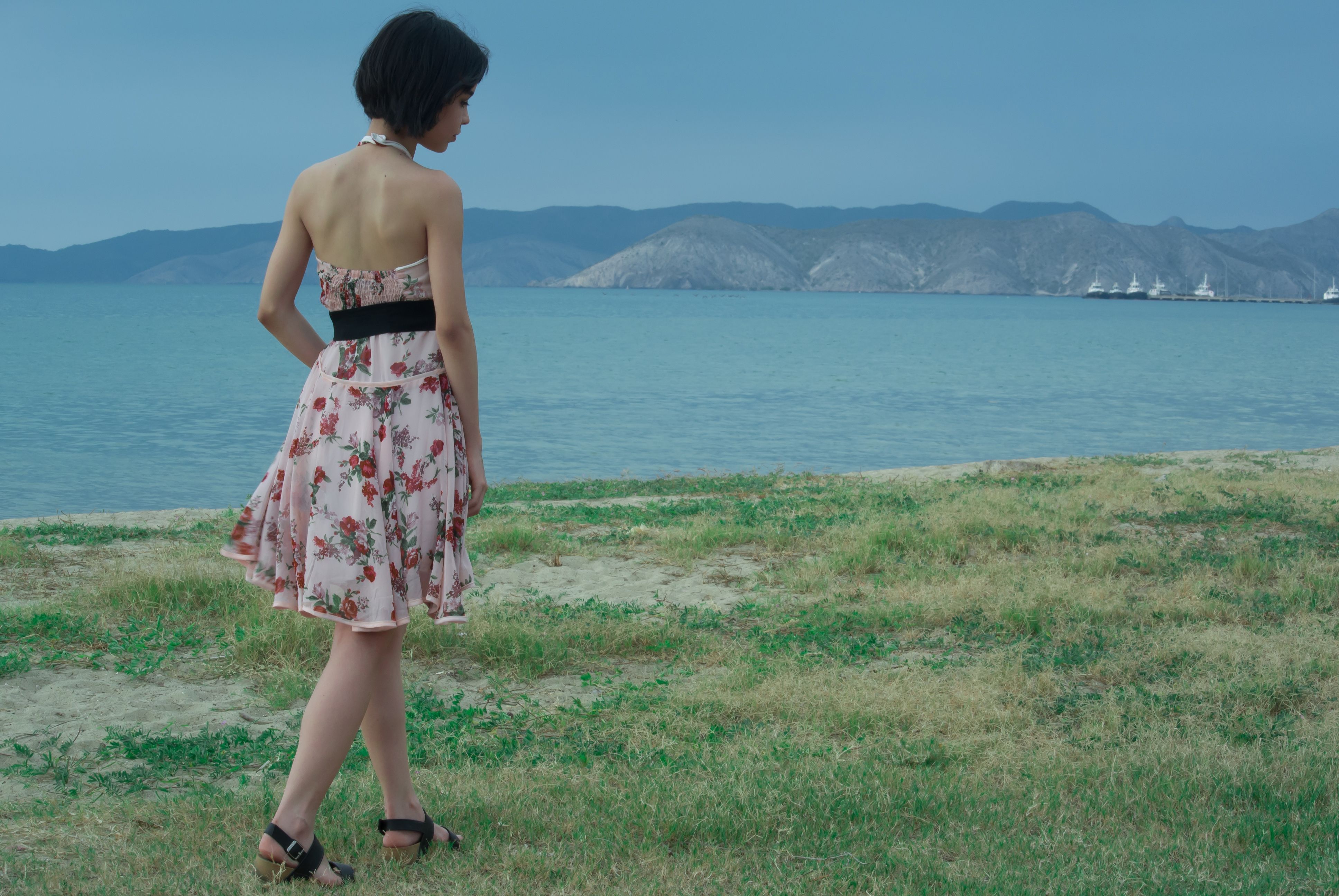 Woman Wearing Pink and White Floral Halter-top Mini Dress · Free Stock ...