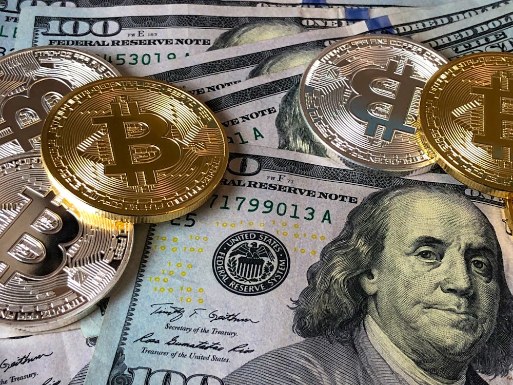 Free Bitcoins and U.s Dollar Bills Stock Photo